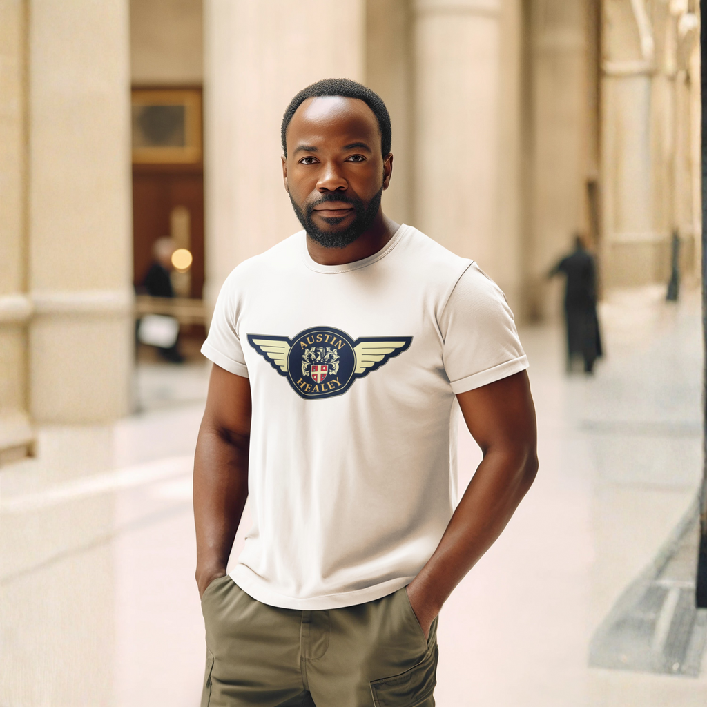 Man wearing a natural t-shirt with a Austin Healey logo in an indoor setting with columns