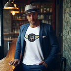Man wearing a suit jacket over a white t-shirt with a Austin Healey logo, standing in a bar setting.
