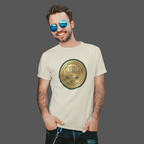 Man wearing a natural t-shirt with a gold classic car emblem and text, standing against a gray background