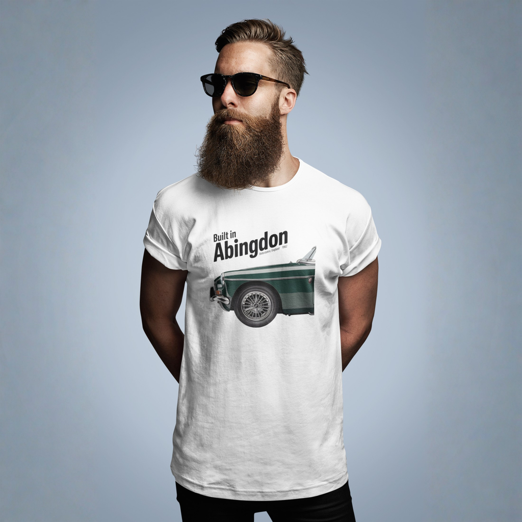Man wearing a white t-shirt with a classic car graphic design and text, standing against a plain background
