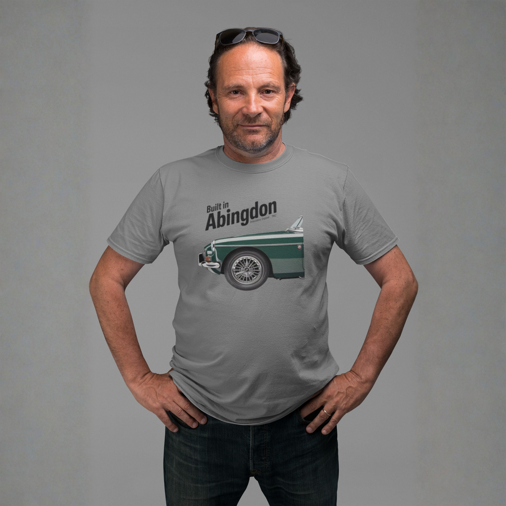 Man wearing a gray t-shirt with a classic car graphic design on a gray background