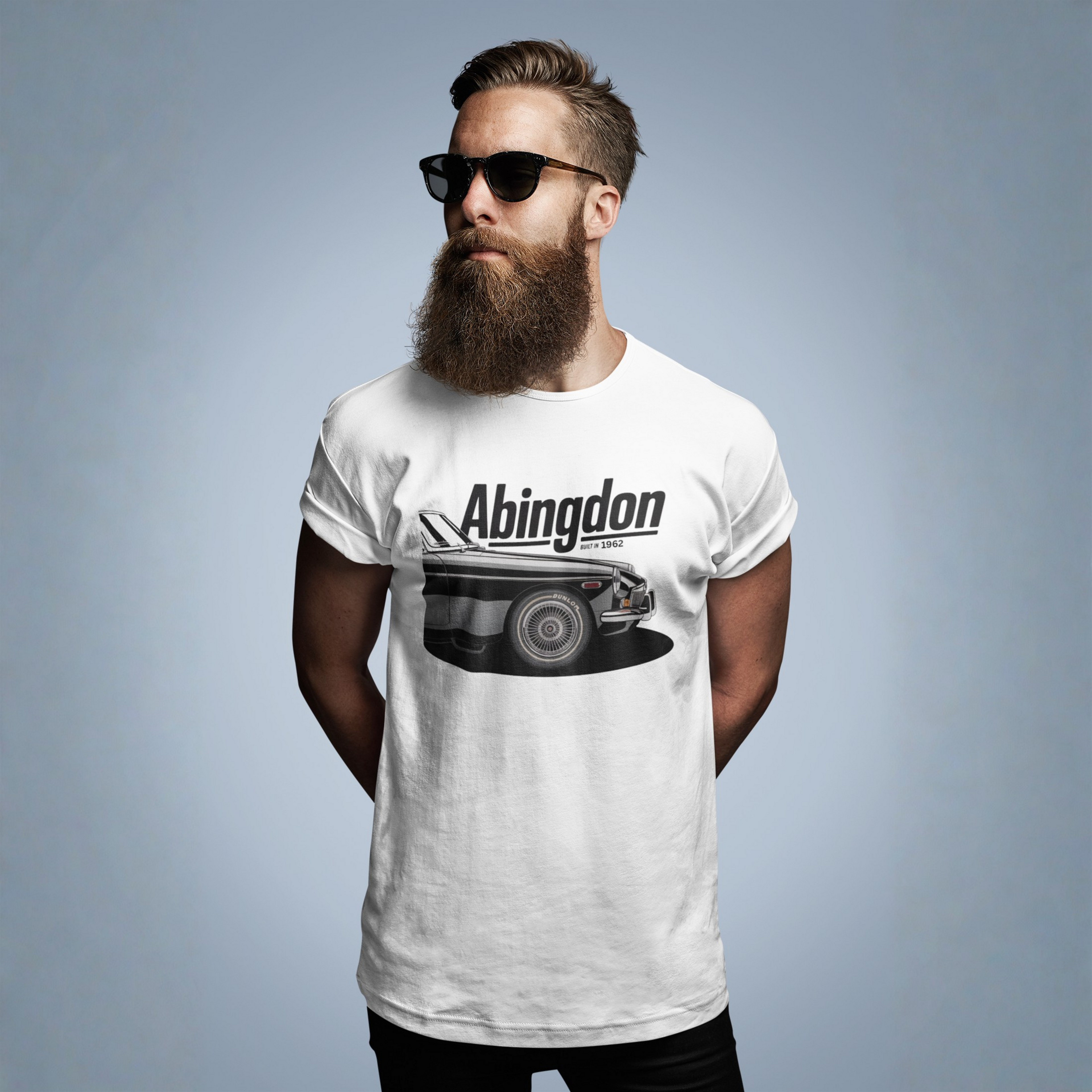 Man wearing a white t-shirt with 'Abingdon' and classic car graphic on a gray background