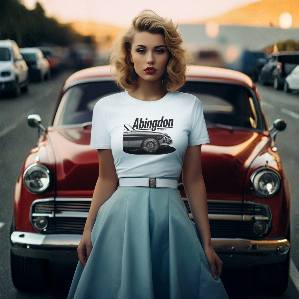 Woman wearing a white t-shirt with 'Abingdon' and classic car graphic in front of a vintage red car.