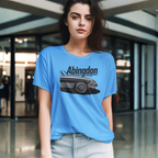 Woman wearing a blue t-shirt with a classic car graphic and text in an indoor setting