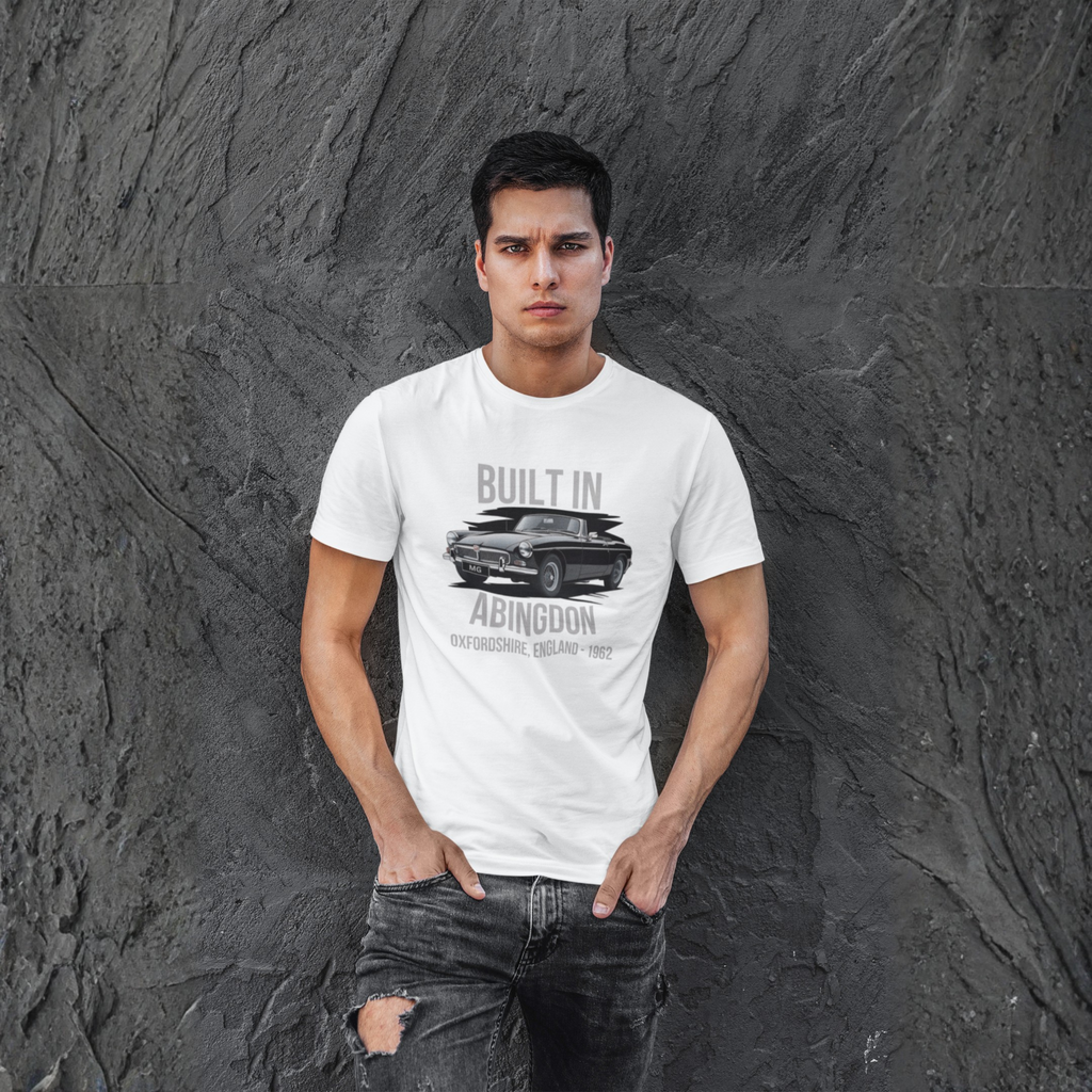 Man wearing a white t-shirt with a classic car graphic design against a textured gray wall