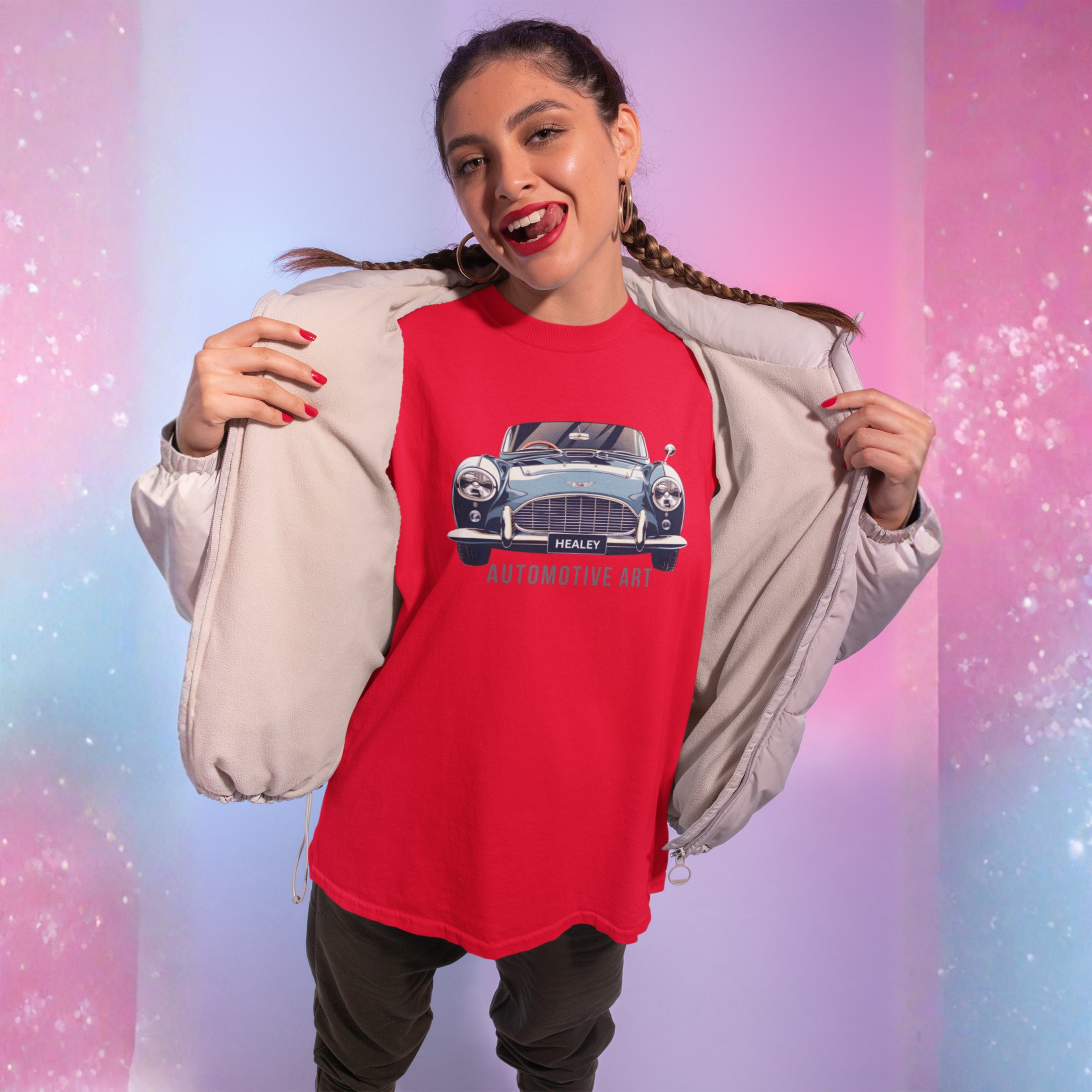 Woman wearing a red t-shirt with a Healey car graphic and text, standing against a gradient background.