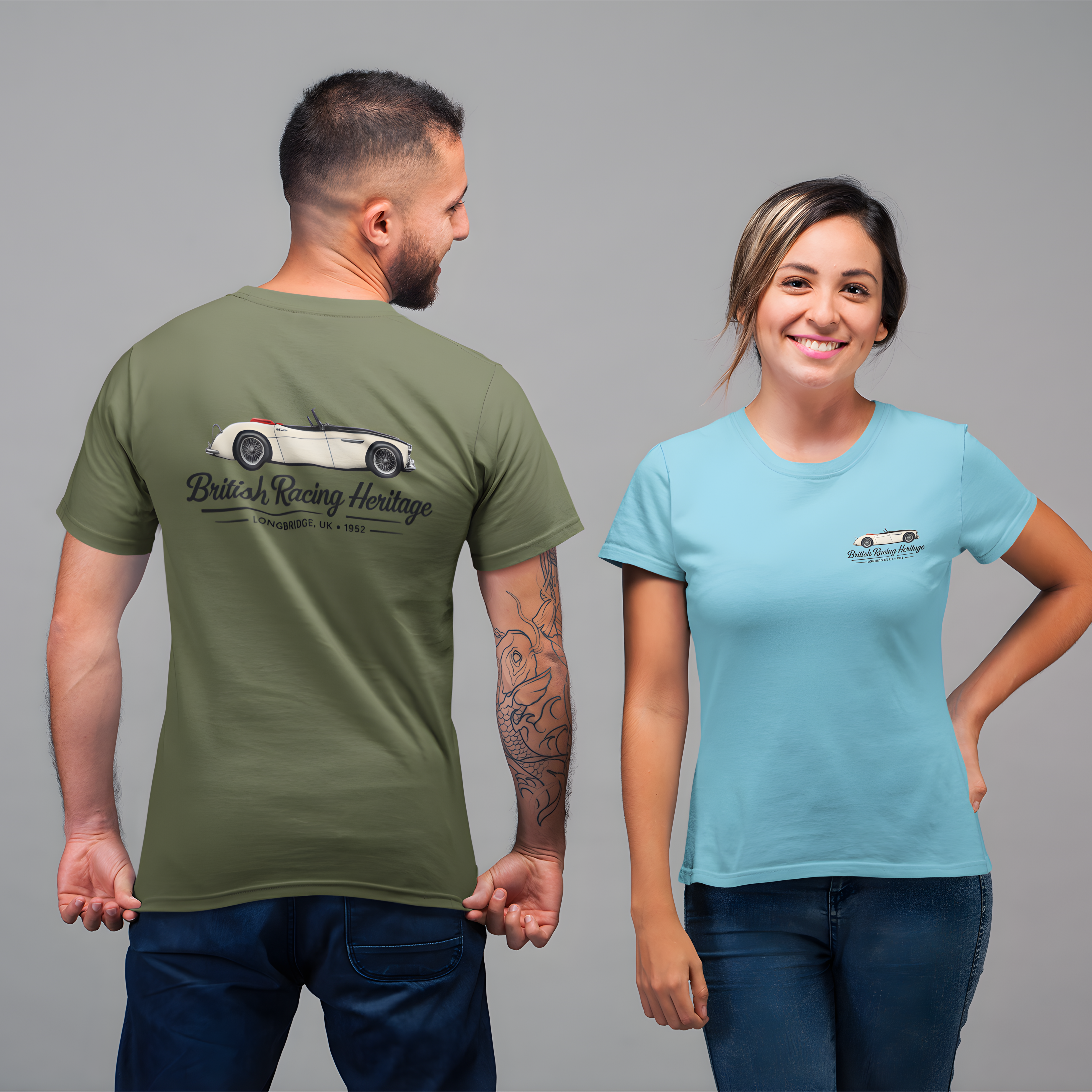 Man and woman wearing t-shirts with a Healey car design and black text on a gray background