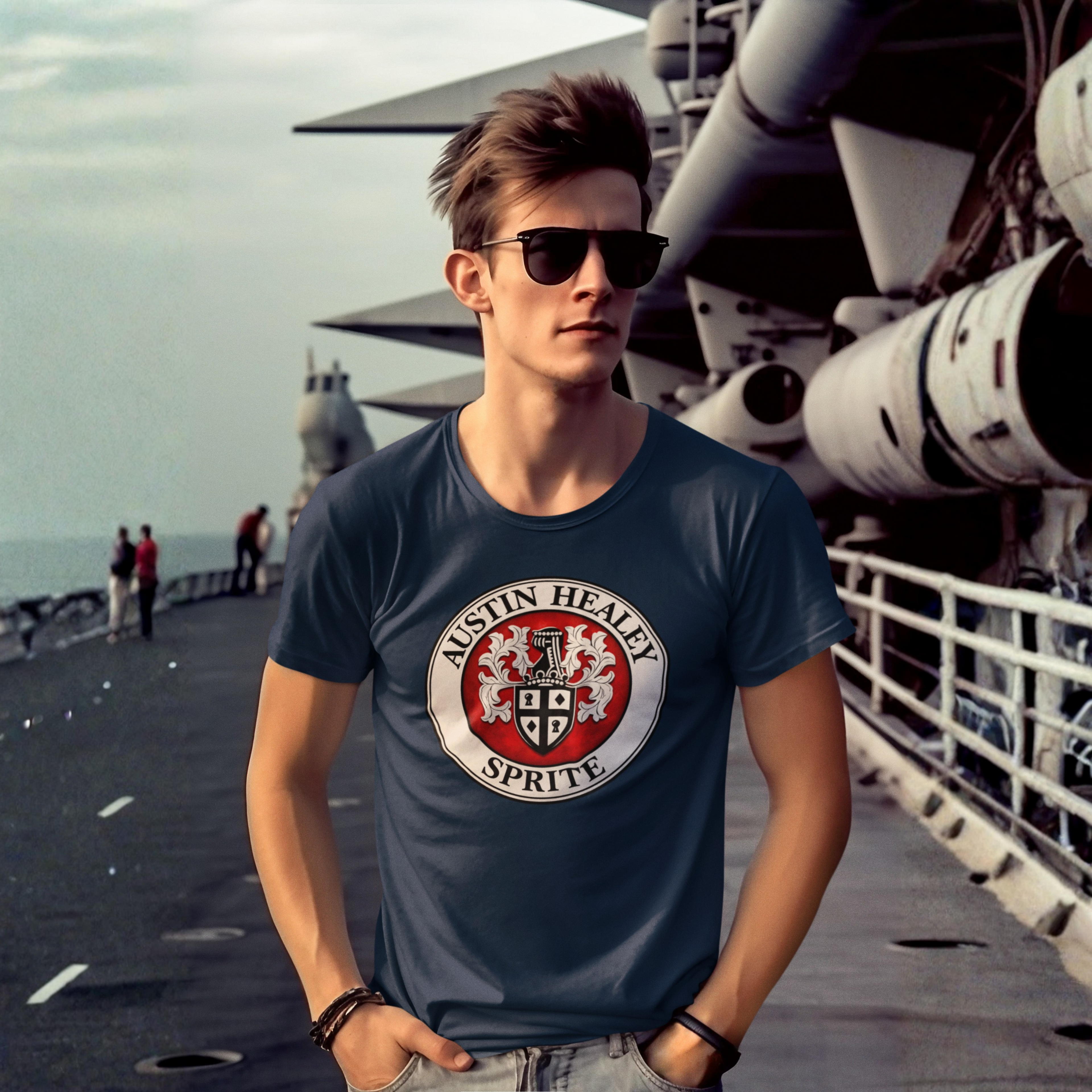 Man wearing a navy blue t-shirt with a Austin Healey Sprite logo on a ship deck