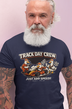 Man wearing a navy blue t-shirt with 'Track Day Crew' graphic design on a light pink background