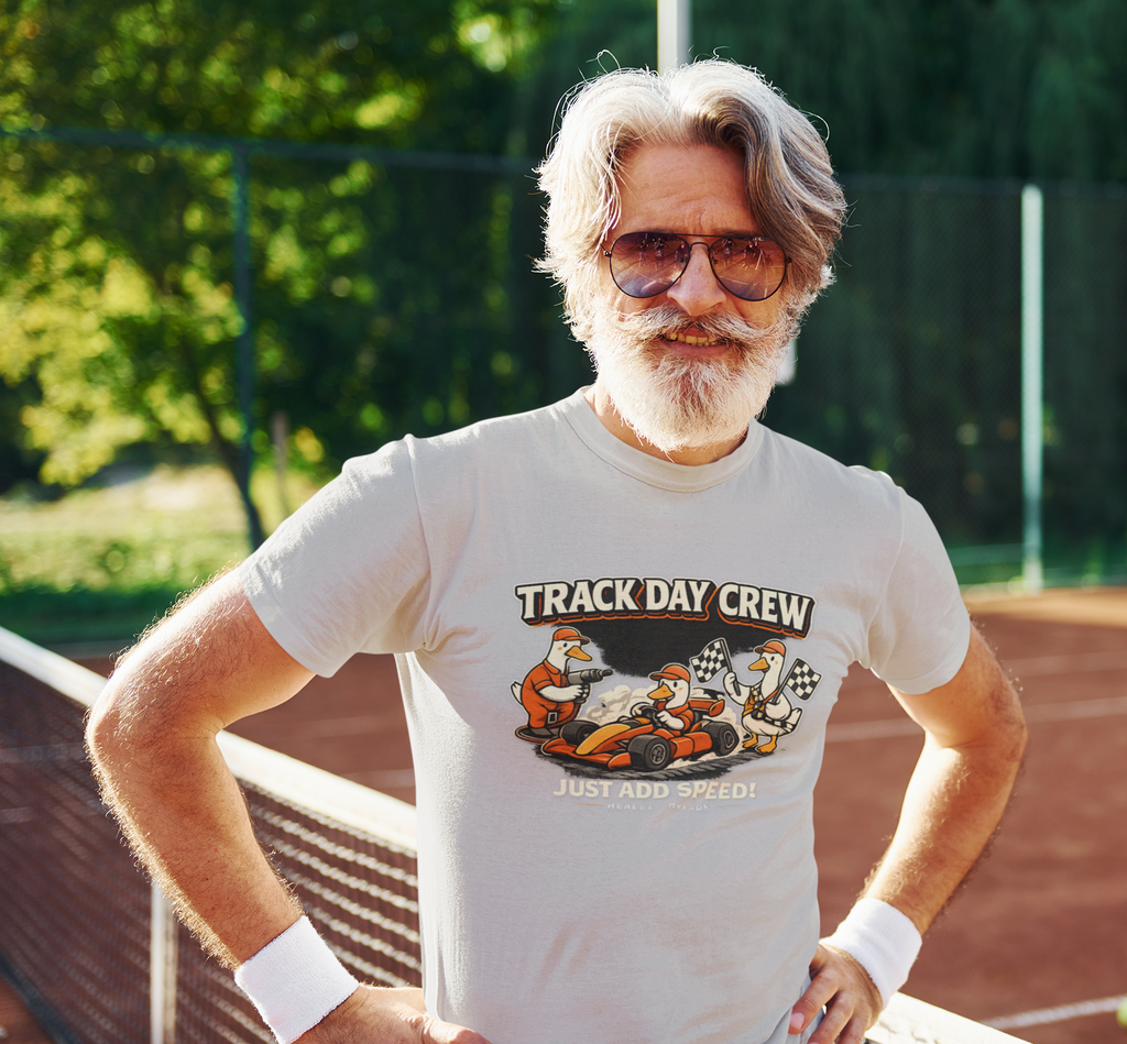 Man wearing a white t-shirt with 'Track Day Crew' graphic outside