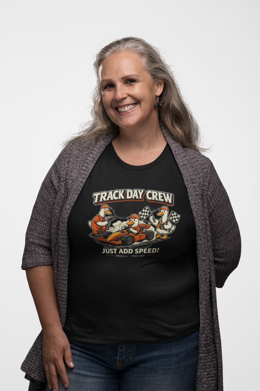 Woman wearing a black t-shirt with 'Track Day Crew' graphic design on a white background