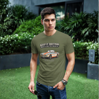 Man wearing a military green t-shirt with a graphic MGB car and text, standing outdoors.