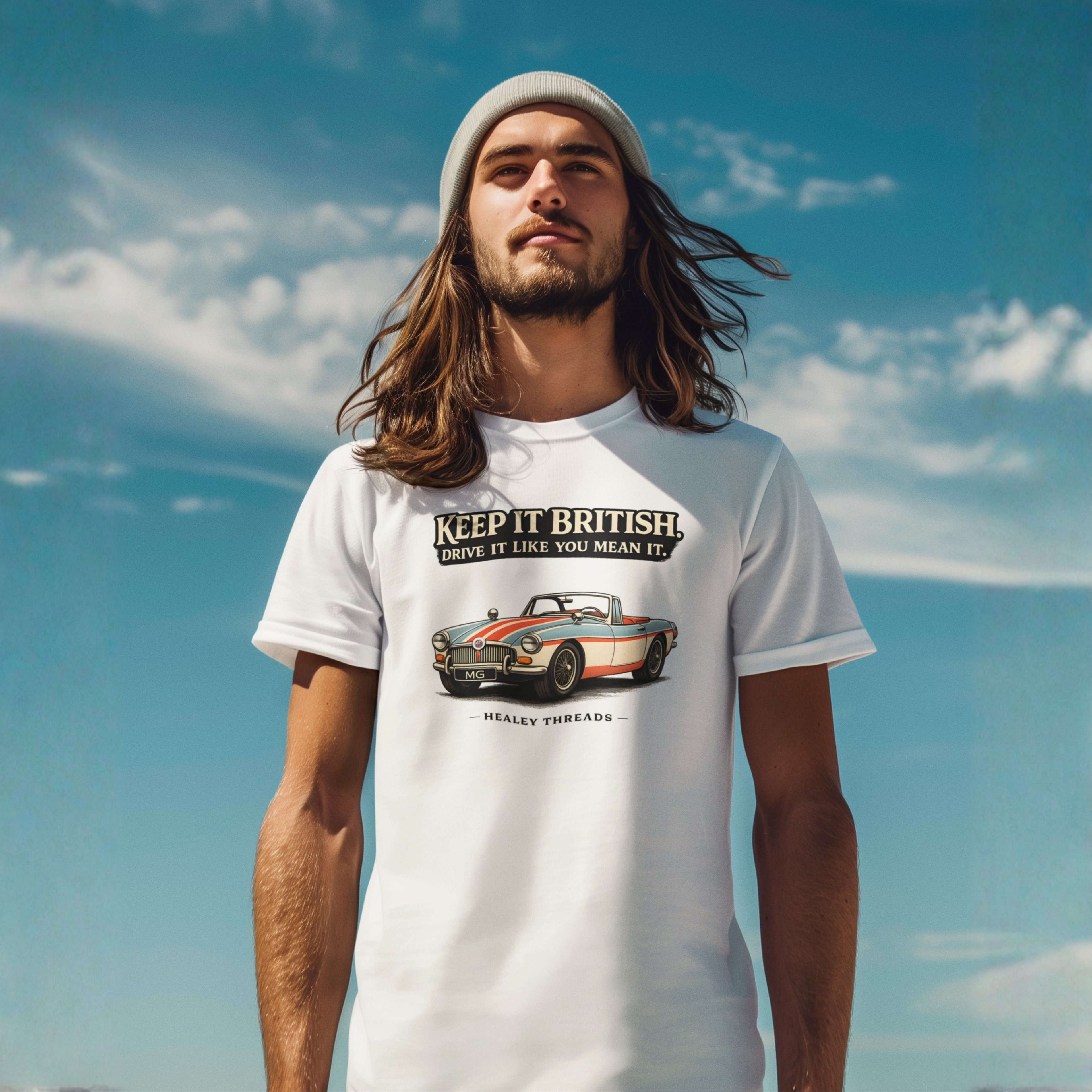 Man wearing a white t-shirt with a graphic MGB car and text against a blue sky.