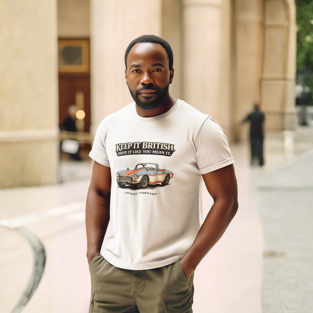Man wearing a natural t-shirt with a graphic MGB car design and text, standing outdoors.