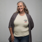 Woman wearing a natural t-shirt with a Healey logo on left chest and a dark cardigan against a gray background
