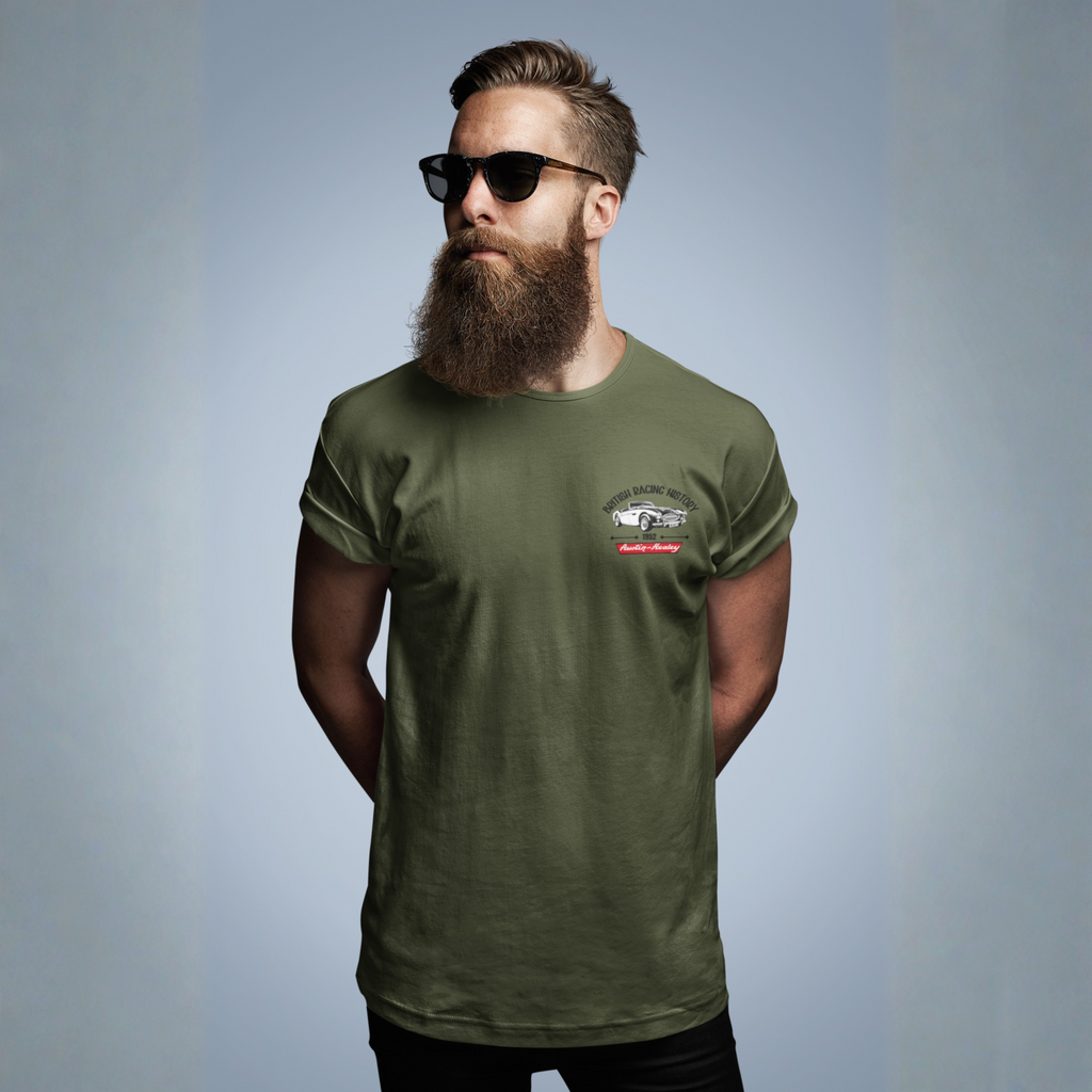 Man wearing a military green t-shirt with a Healey logo on left chest, on a gray background