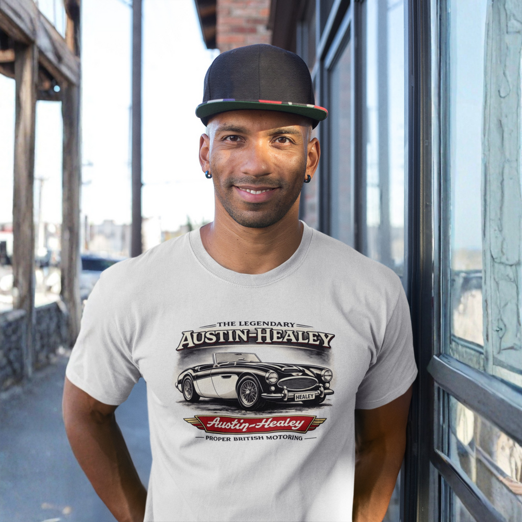 Man wearing a natural t-shirt with an Austin-Healey graphic design outdoors.