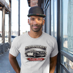Man wearing a natural t-shirt with an Austin-Healey graphic design outdoors.