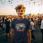Man wearing a navy blue t-shirt with Austin-Healey logo at a outdoor event.