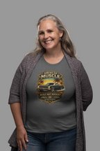 Woman wearing a military green t-shirt with 'American Muscle' car graphic design on a gray background