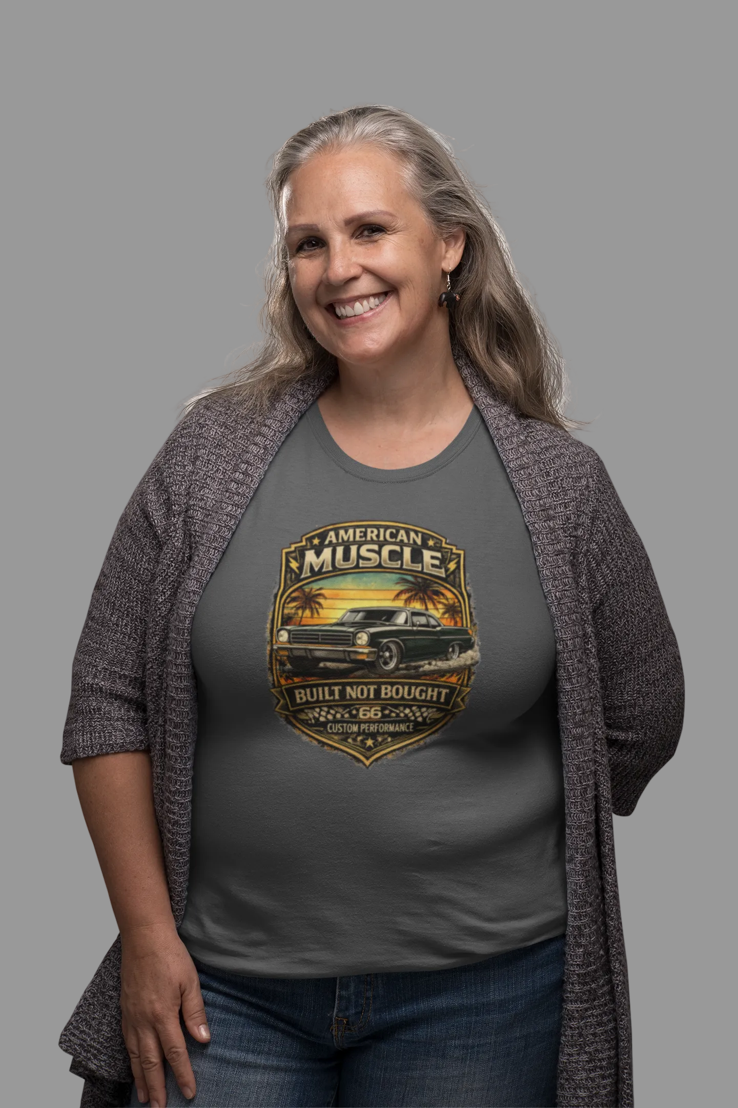 Woman wearing a military green t-shirt with 'American Muscle' car graphic design on a gray background