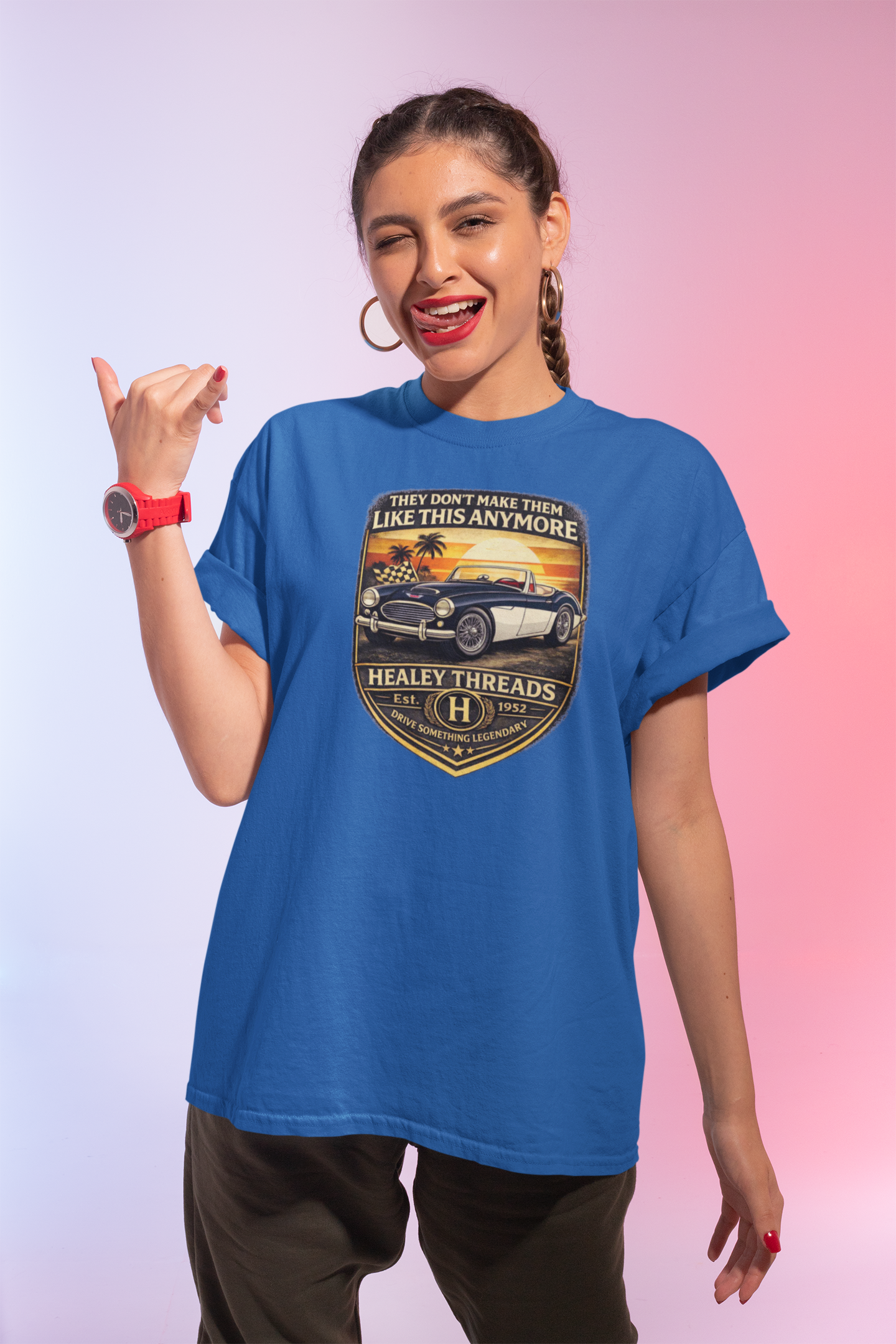Woman wearing a royal blue t-shirt with a graphic car design on a gradient background