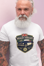 Man wearing a white t-shirt with Healey Threads logo on a pink background