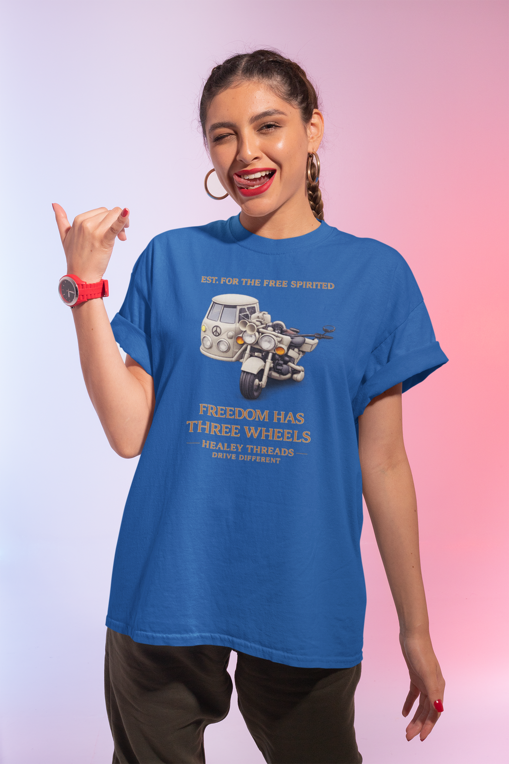 Woman wearing a blue t-shirt with a graphic motorcycle with a sidecar and text on a gradient background