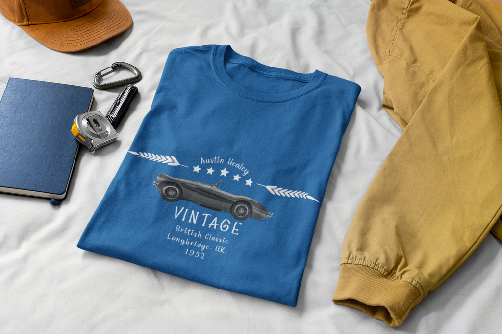 Royal blue t-shirt with vintage car design on a white surface with accessories.