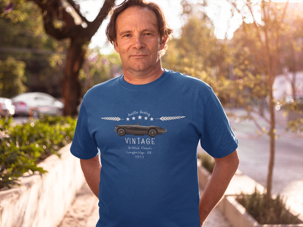 Man wearing a royal blue t-shirt with a vintage car design outdoors.