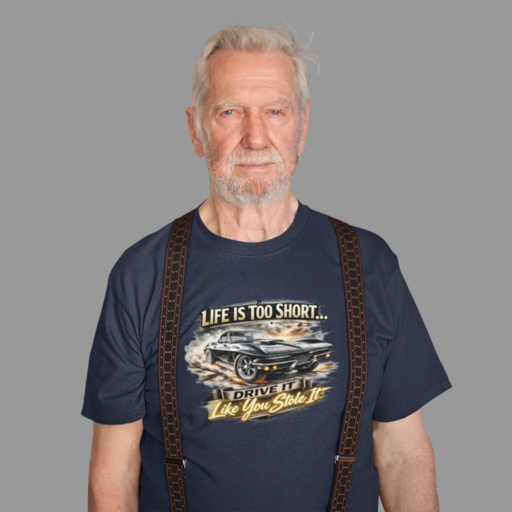 Man wearing a navy blue t-shirt with a classic car graphic design and text on a white background