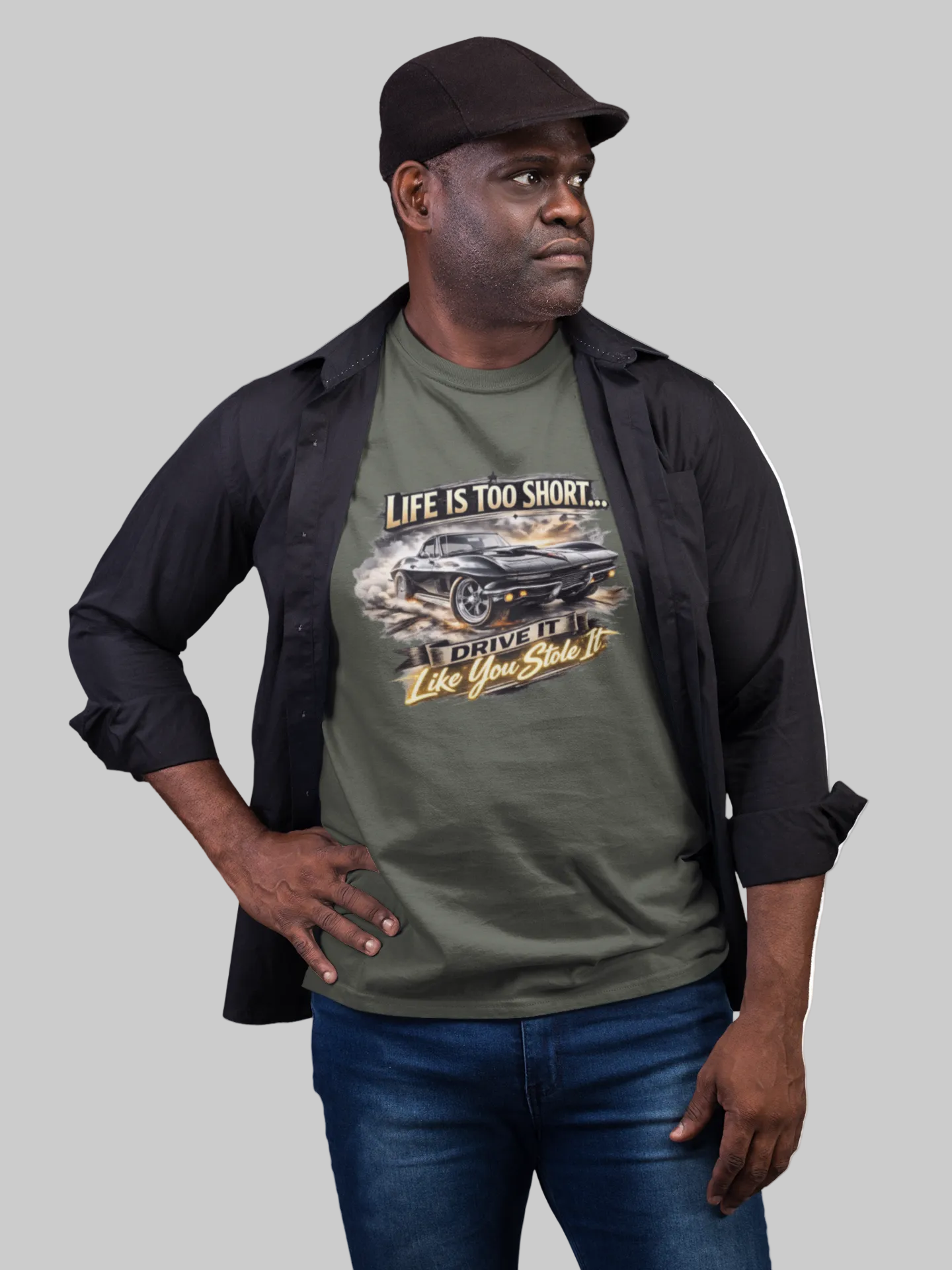 Man wearing a military green t-shirt with a classic car graphic design on a gray background