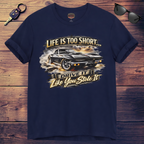 Navy blue t-shirt with classic car graphic and text on a wooden surface