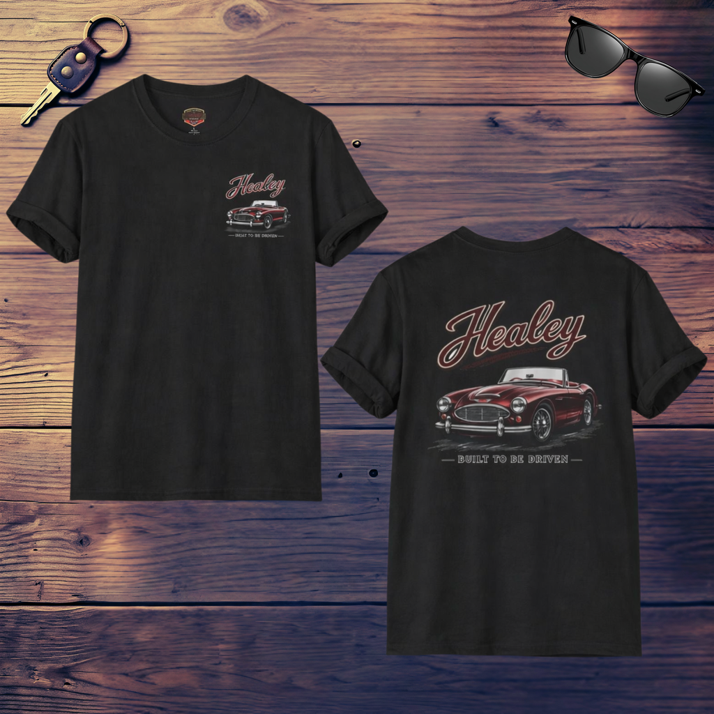 Front and back of a black t-shirt with Healey car design on a wooden surface with sunglasses and keys.