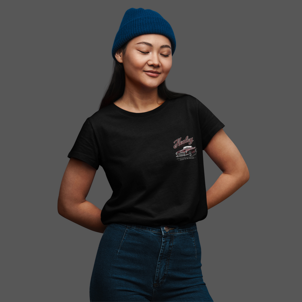 Woman wearing a black t-shirt with a logo and a blue beanie on a gray background