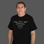Man wearing a black t-shirt with vintage car design on a gray background