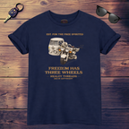Navy blue t-shirt with graphic tri bike design and text on a wooden surface with sunglasses and keychain.