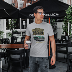 Man wearing a sport gray t-shirt with a classic car graphic design in an outdoor cafe setting