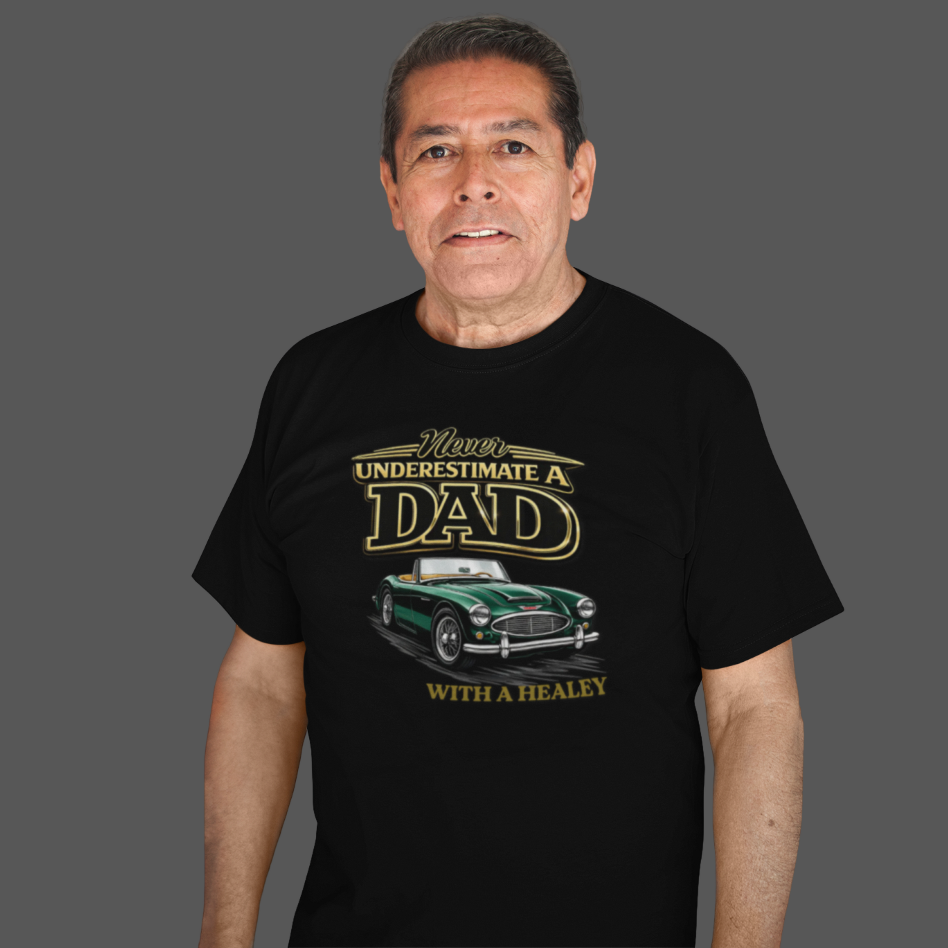 Man wearing a black t-shirt with a classic car graphic design and text on a gray background