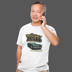 Man wearing a white t-shirt with a classic car graphic design and text, talking on a phone.