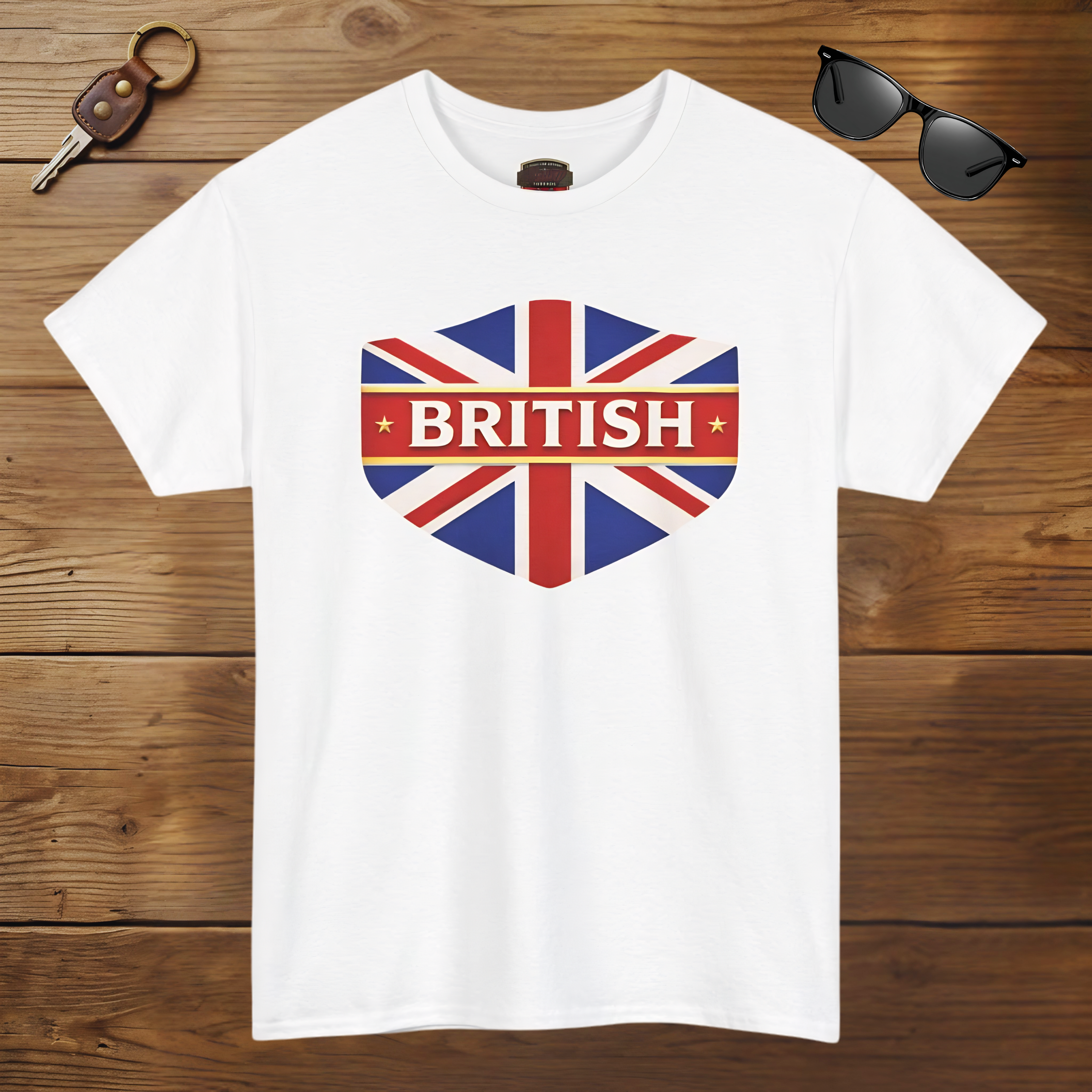 White t-shirt with British flag design and 'BRITISH' text on a wooden surface with sunglasses and keychain.