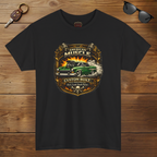Black t-shirt with 'American Muscle' graphic design on a wooden surface with sunglasses and keychain.