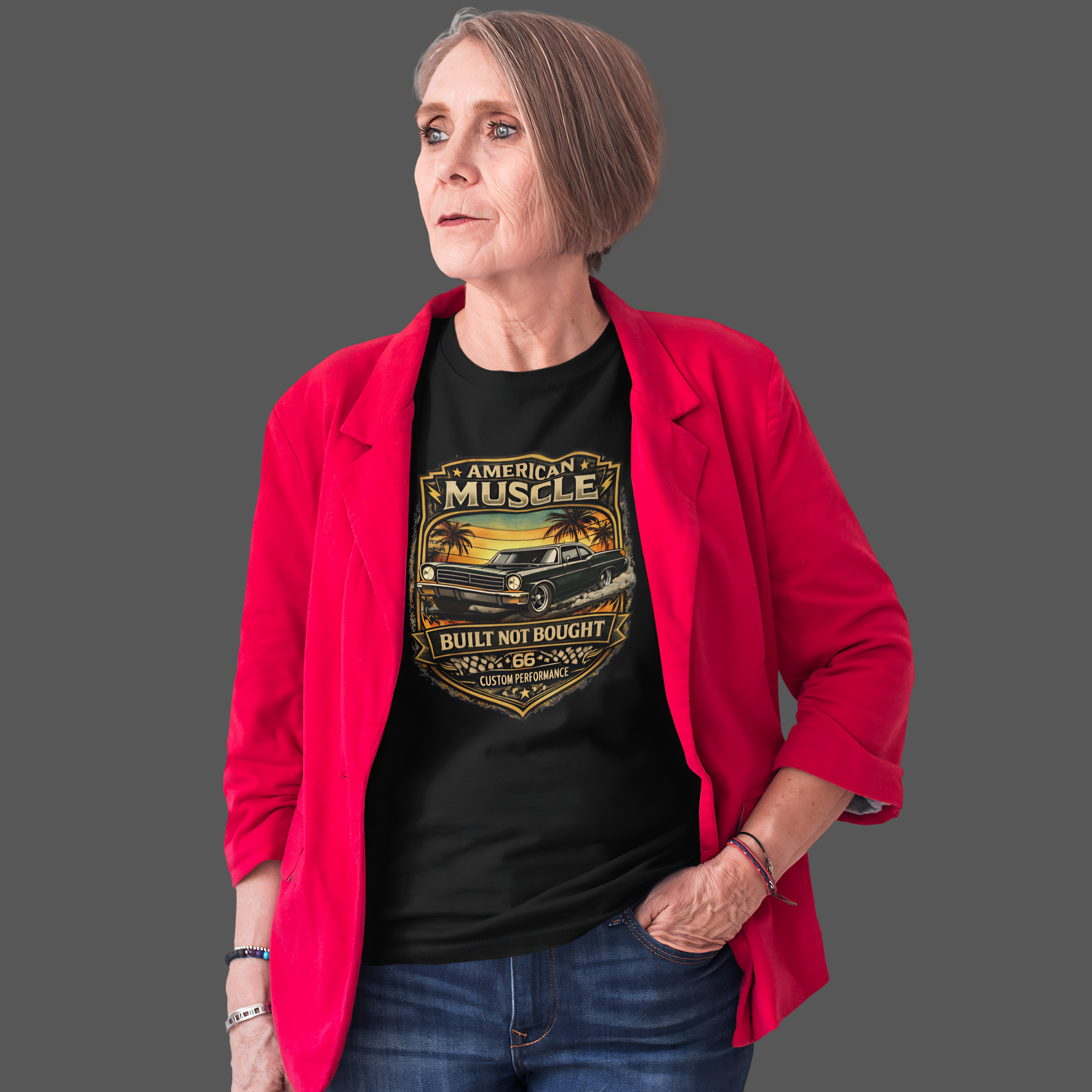 Woman wearing a black t-shirt with 'American Muscle' car graphic and a red jacket on a gray background