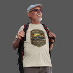 Man wearing a white t-shirt with a classic car graphic design and carrying a backpack on a gray background