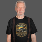 Man wearing a black t-shirt with 'American Muscle' car graphic design on a gray background