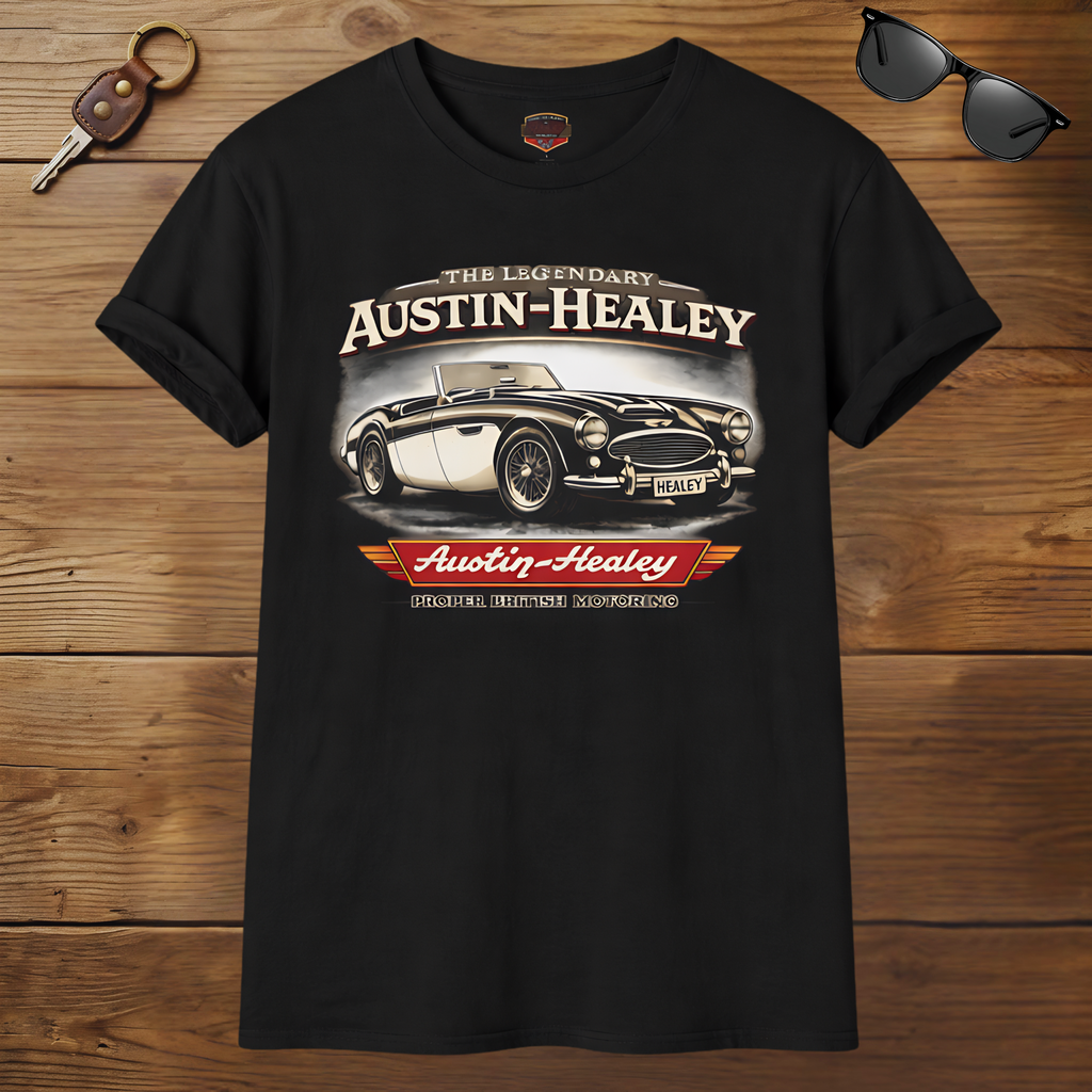 Black t-shirt with Austin-Healey car design on a wooden surface with sunglasses and keychain.