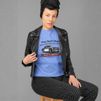 Woman wearing a Carolina blue t-shirt with a graphic design and black leather jacket on a gray background