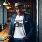 Man wearing a white t-shirt with a graphic Healey design, standing in a bar setting.