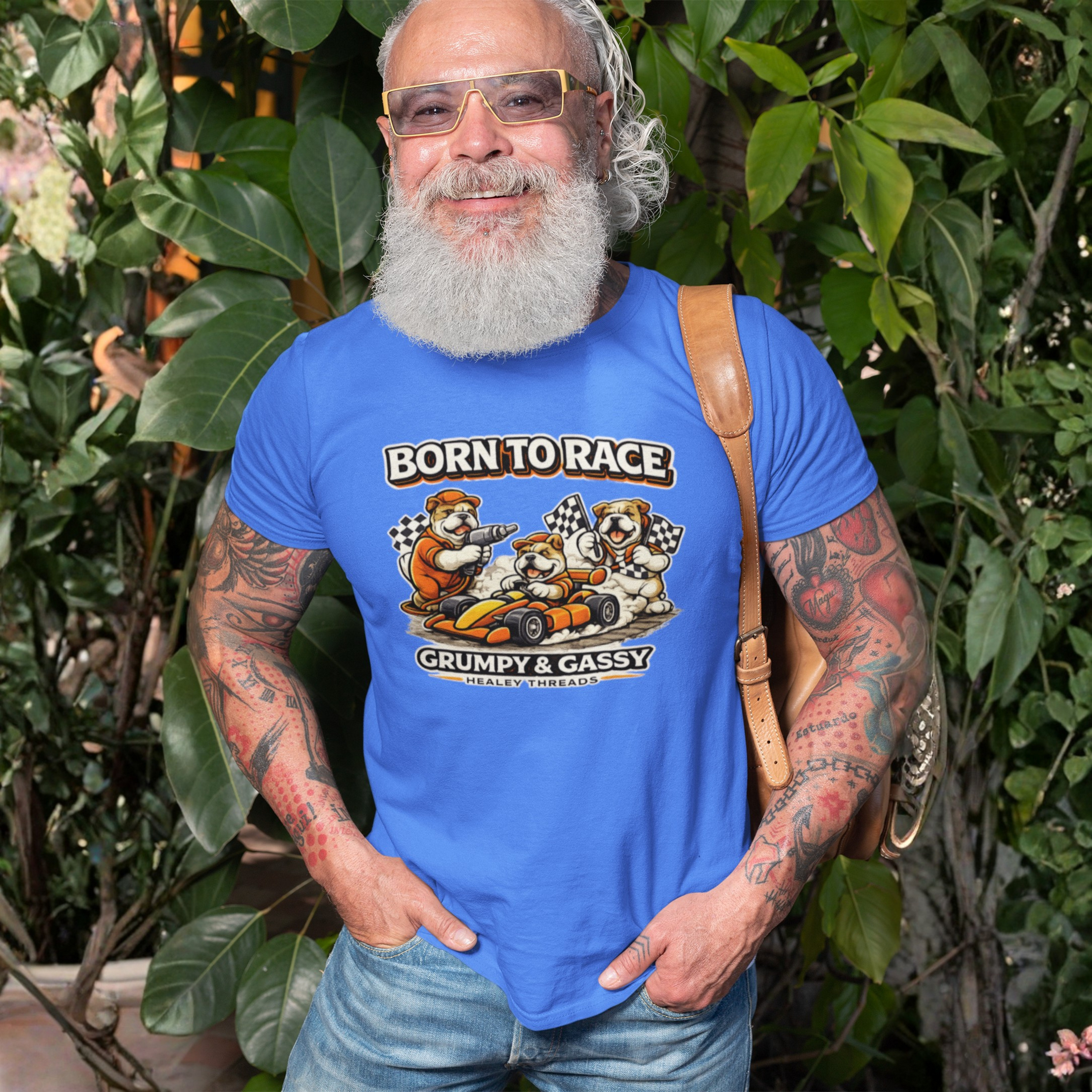 Man wearing a Carolina blue t-shirt with 'Born to Race Grumpy & Gassy' design, standing outdoors.