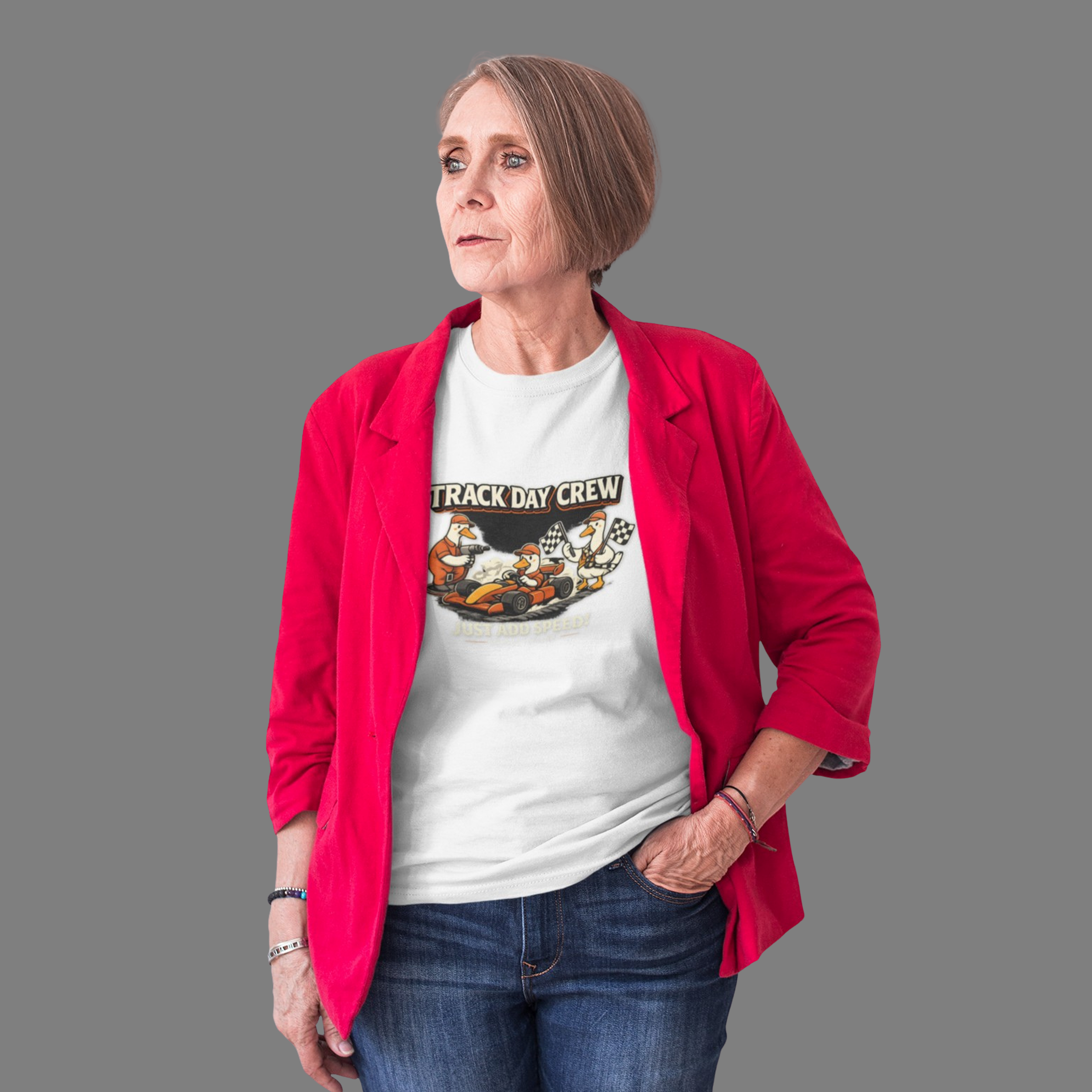 Woman wearing a red jacket over a white t-shirt with 'Track Day Crew' graphic on a gray background
